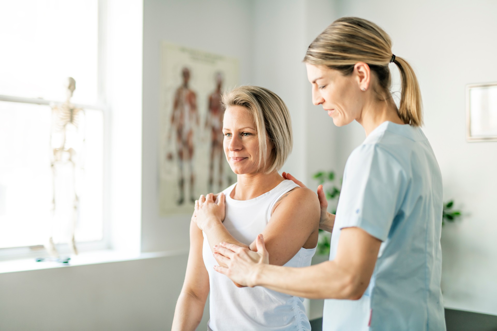 A Modern rehabilitation physiotherapy worker with woman client