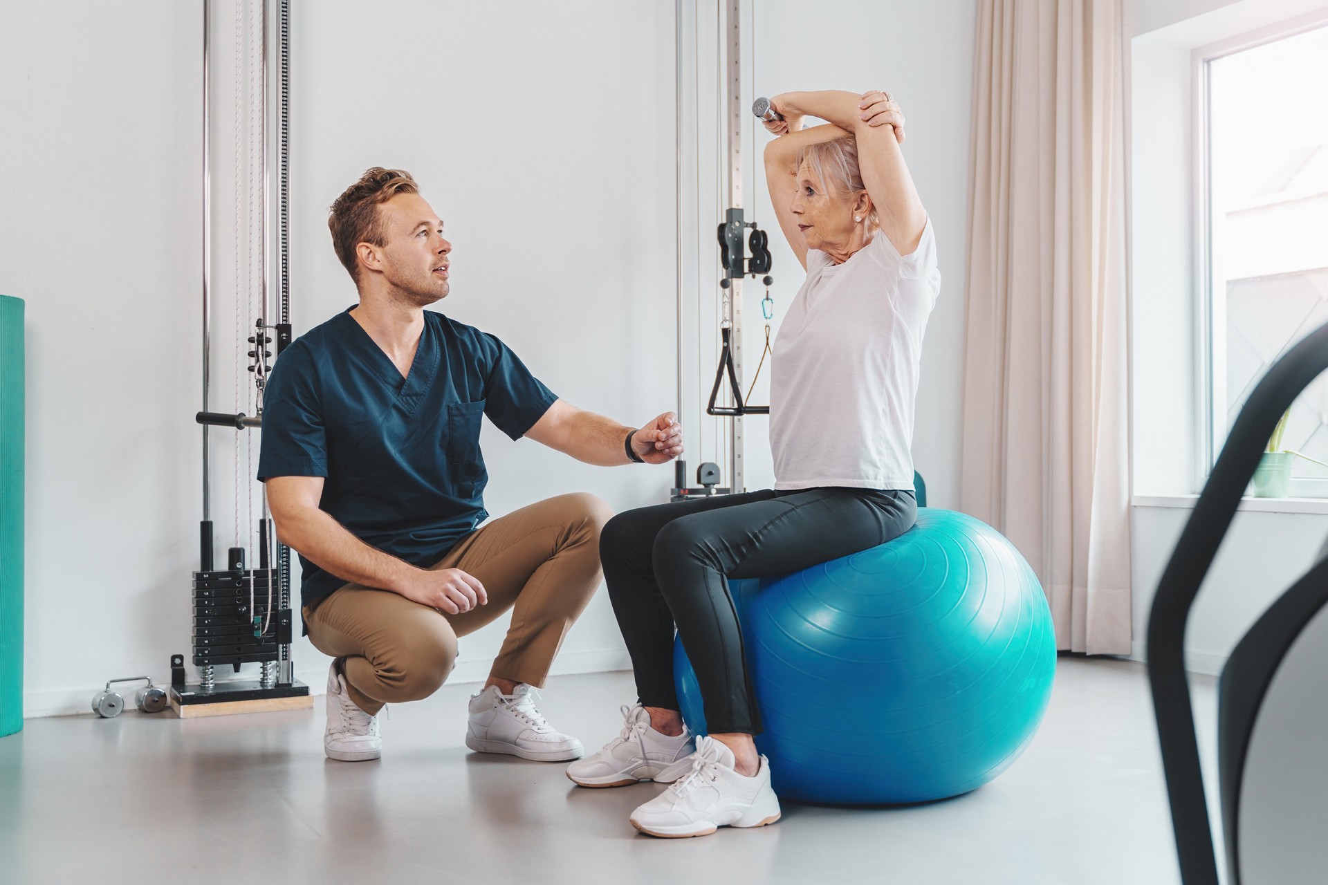 Senior Woman and Trainer in Gym Session