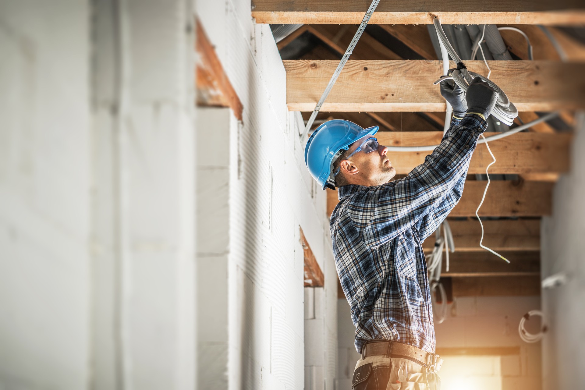 Electrician Installing Wiring System in the Ceiling