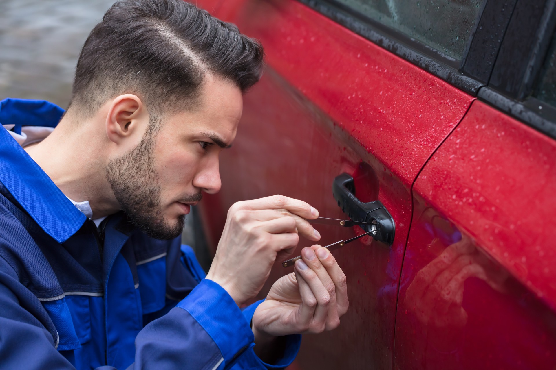 Man Opening Car Door With Lockpicker